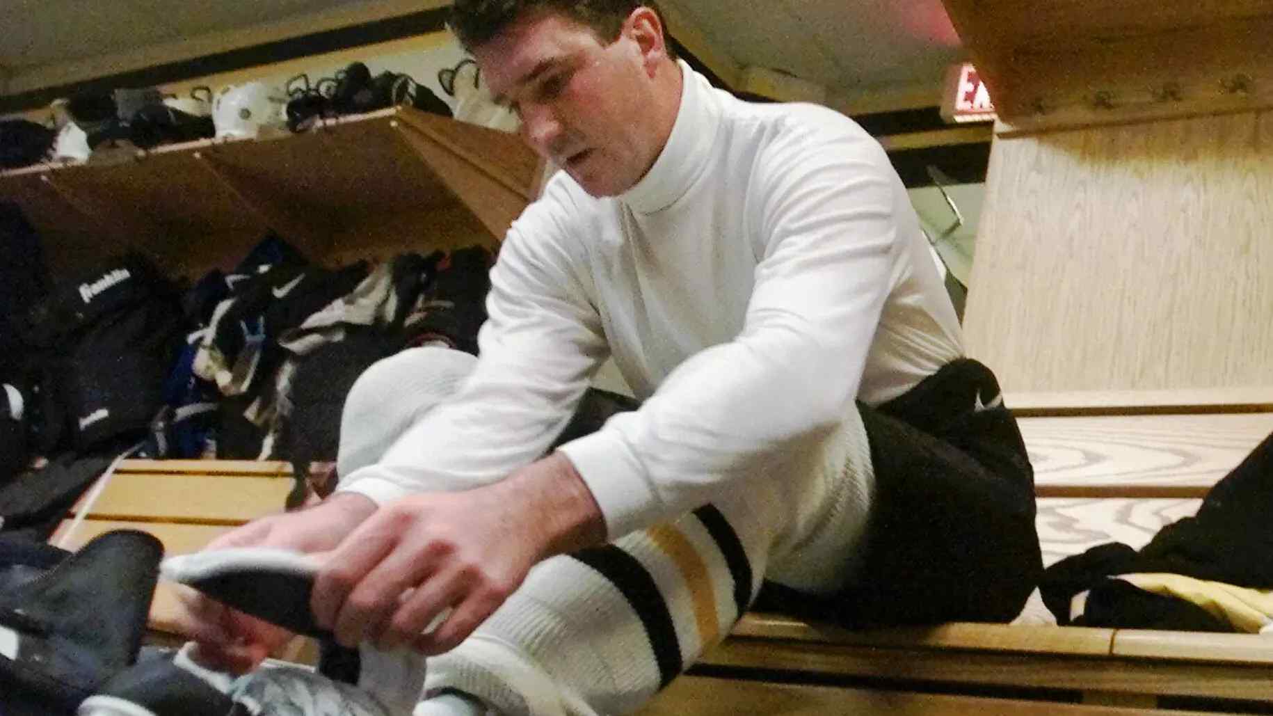Mario Lemieux lacing up his skates after coming back from retirement.